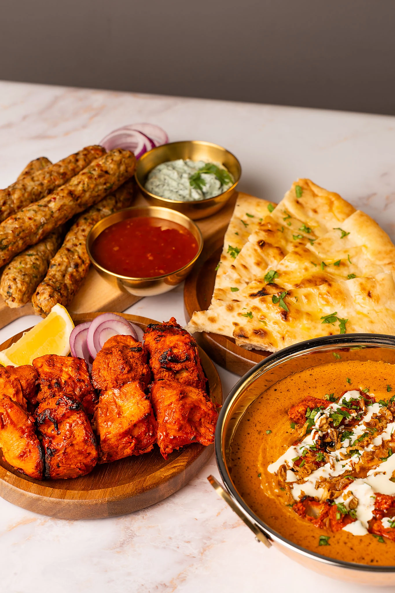 A colourful selection of chicken tikka, seekh kebabs, rice and curry